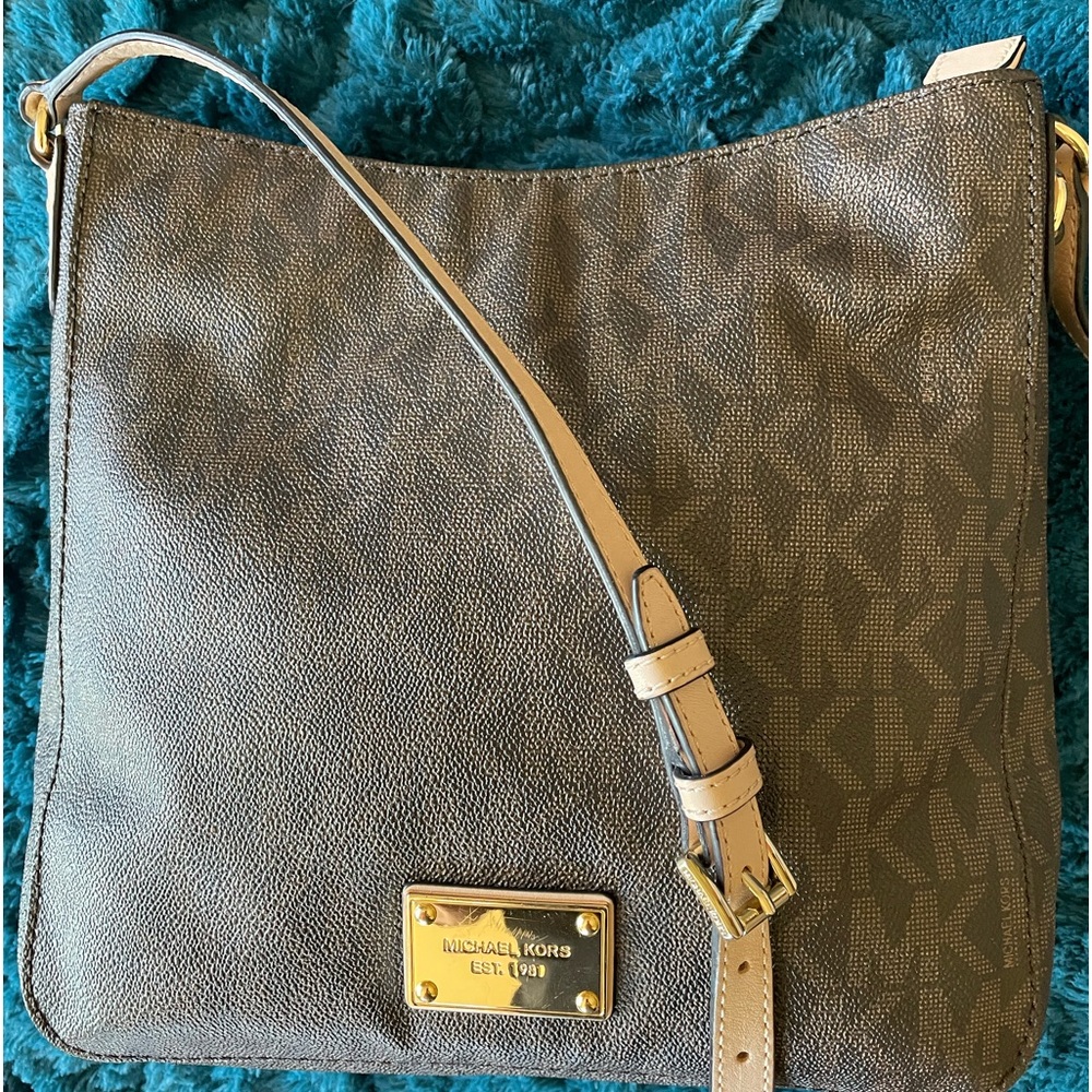 Michael Kors  lightly used leather crossbody. Logo imprinted throughout.
